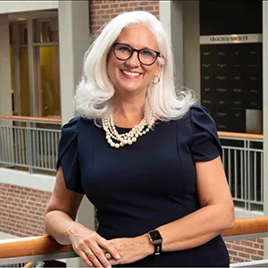 Jules Morris in a navy dress and pearls inside the Haslam College of Business