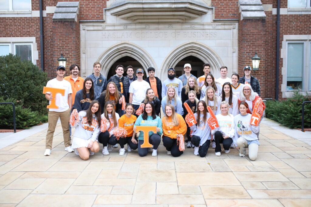 Jules with a class of students in Tennessee orange on the steps of the Haslam College of Business