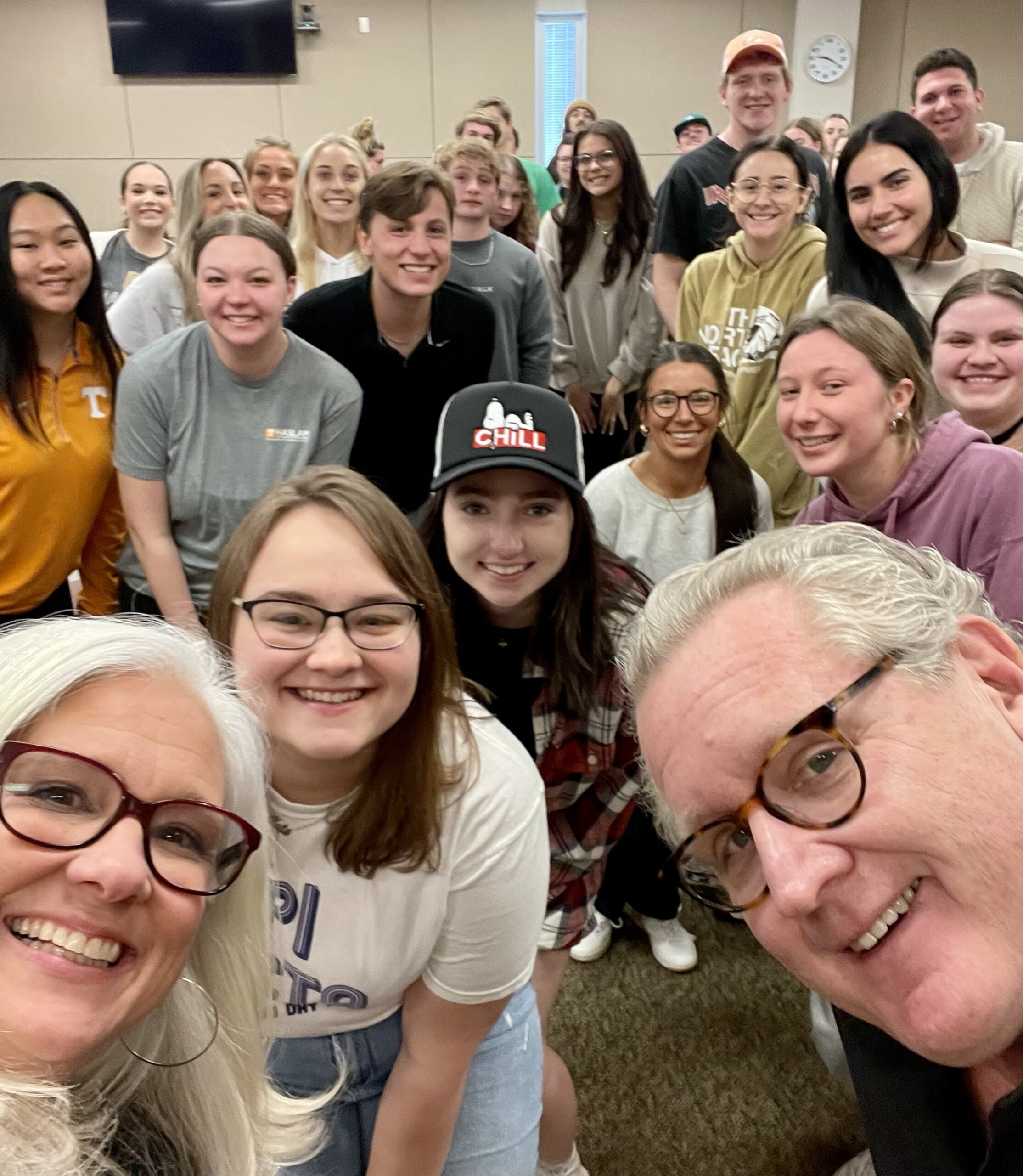 A classroom selfie of Jules with a room full of smiling students