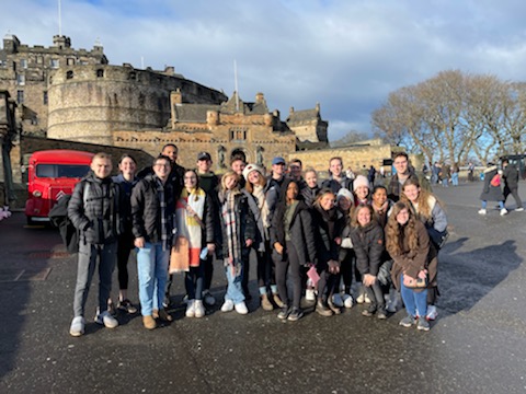 Students in winter coats in front of Edinburgh Castle