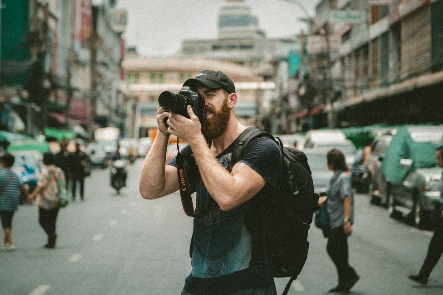 A photographer shooting on a busy city street