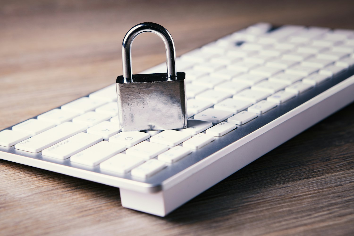 A padlock resting on a computer keyboard