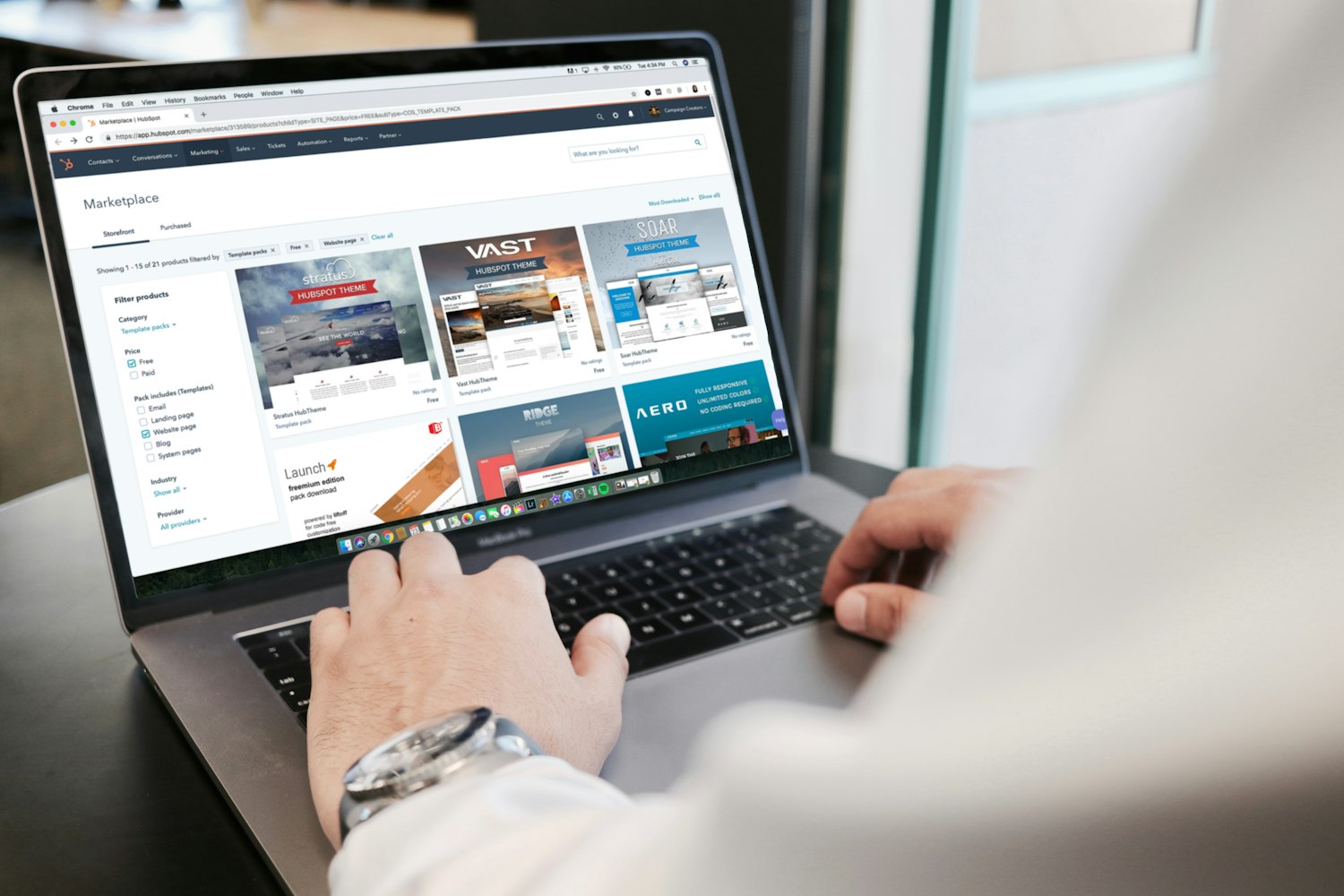 Hands on a laptop browsing a website