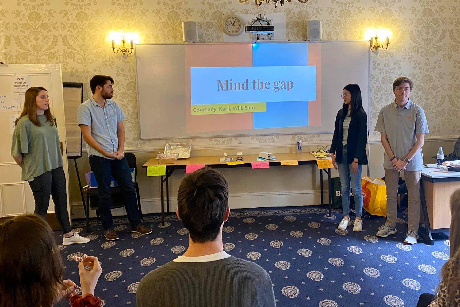 A student team presenting their final project to the class