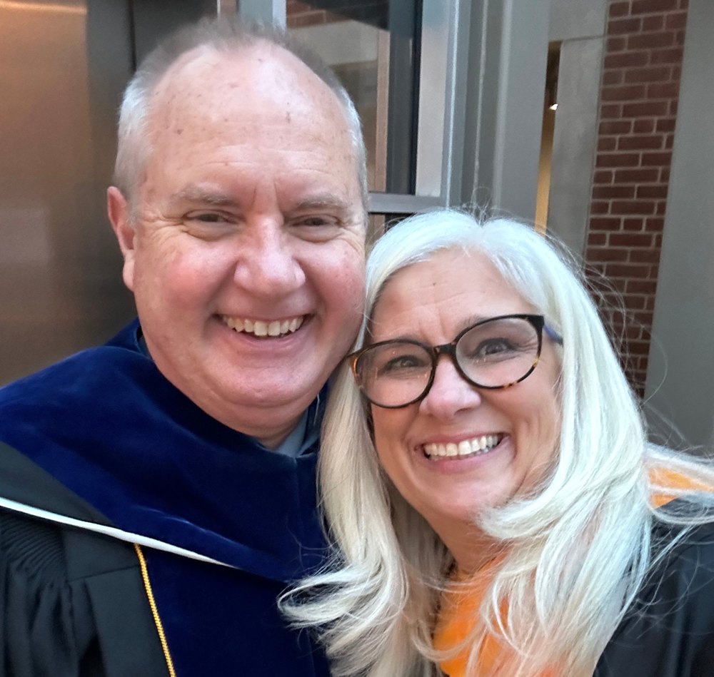 Lane Morris and Jules Morris smiling together in academic regalia