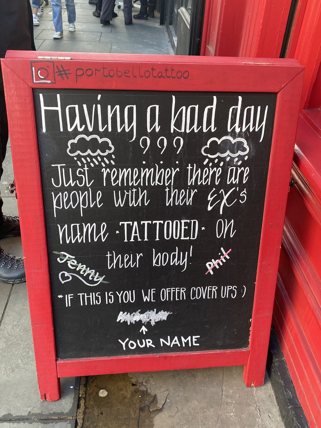 A chalkboard sign outside a shop reading Having a bad day?