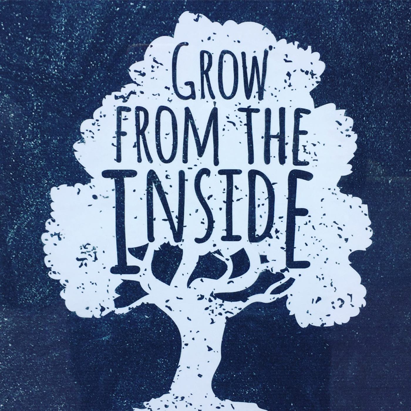 Shop window art of a tree reading Grow from the inside