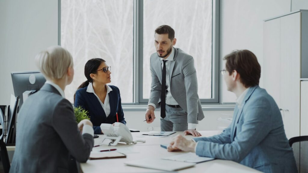 Small group of professionals in a discussion around a meeting table