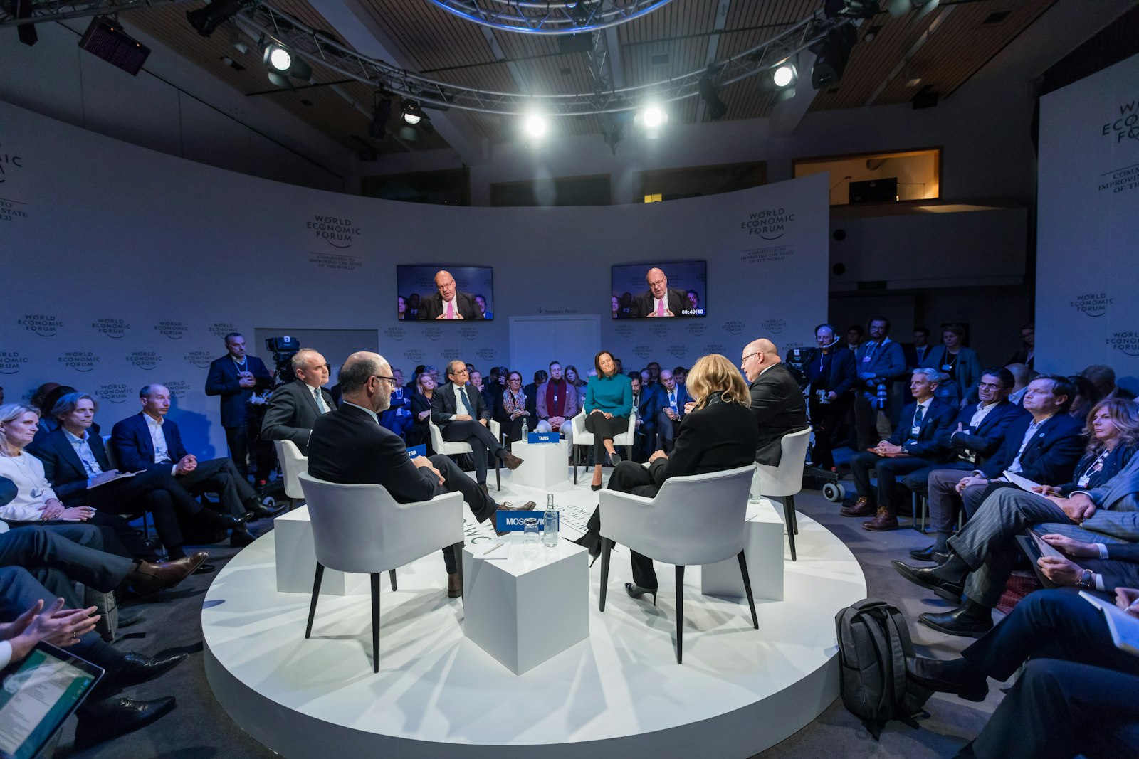 Executives speaking on a panel at an industry conference