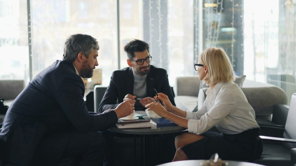 Colleagues in a development conversation around a table