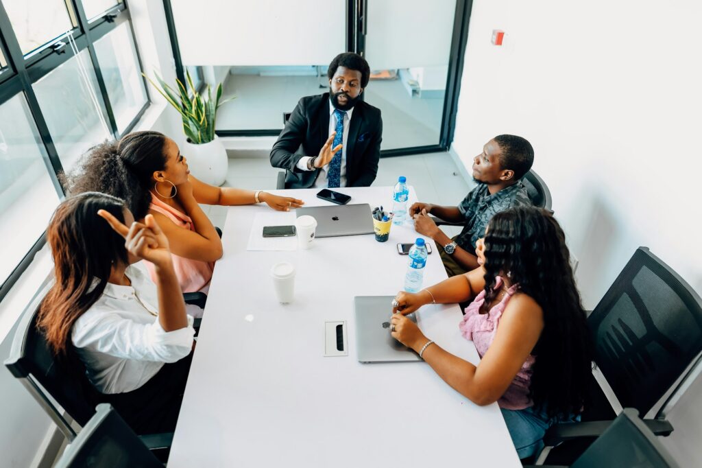 A team meeting around a long table in a bright office