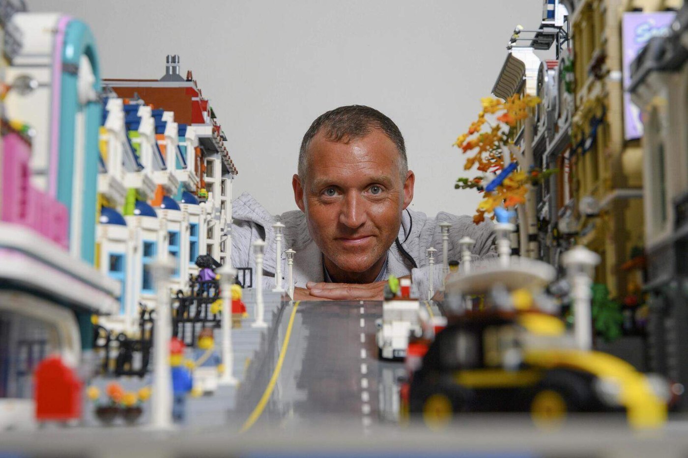 YouTuber Graham Young, The Lego Leprechaun, posed in a LEGO city scene