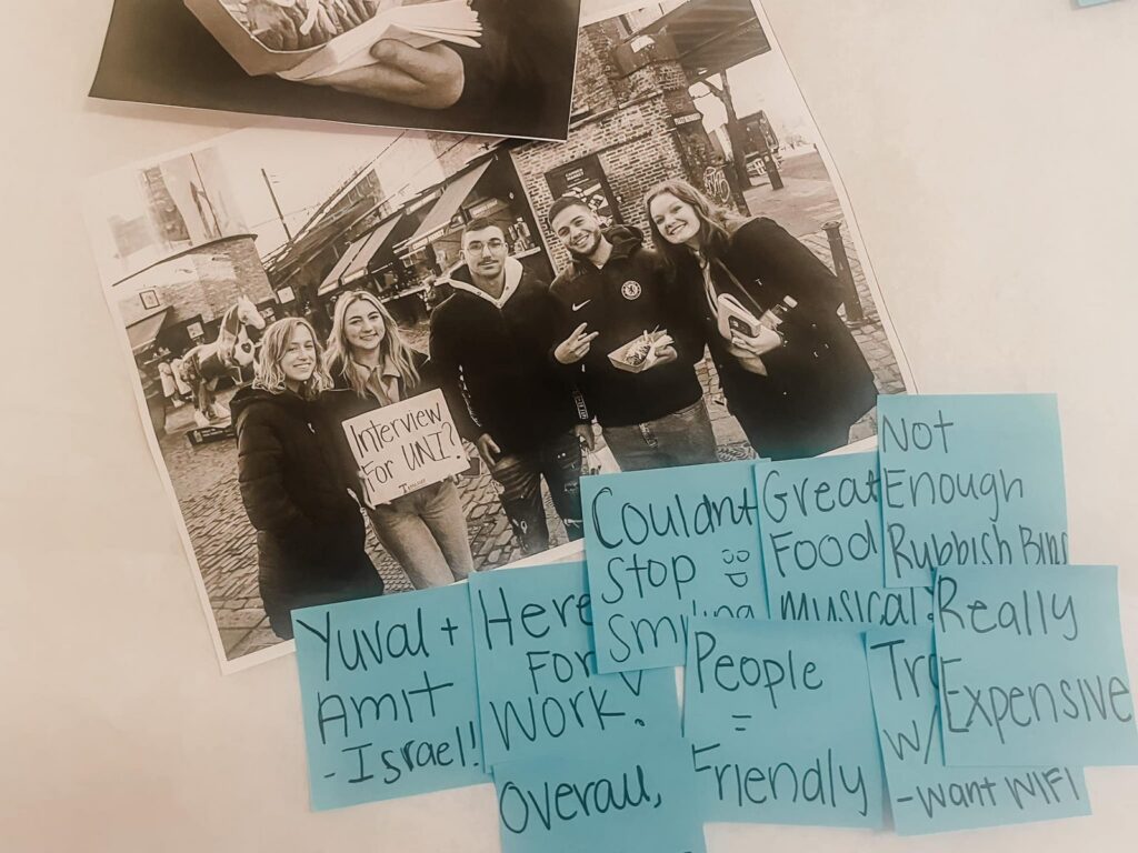 Black and white interview photos covered with blue sticky notes of quotes and observations
