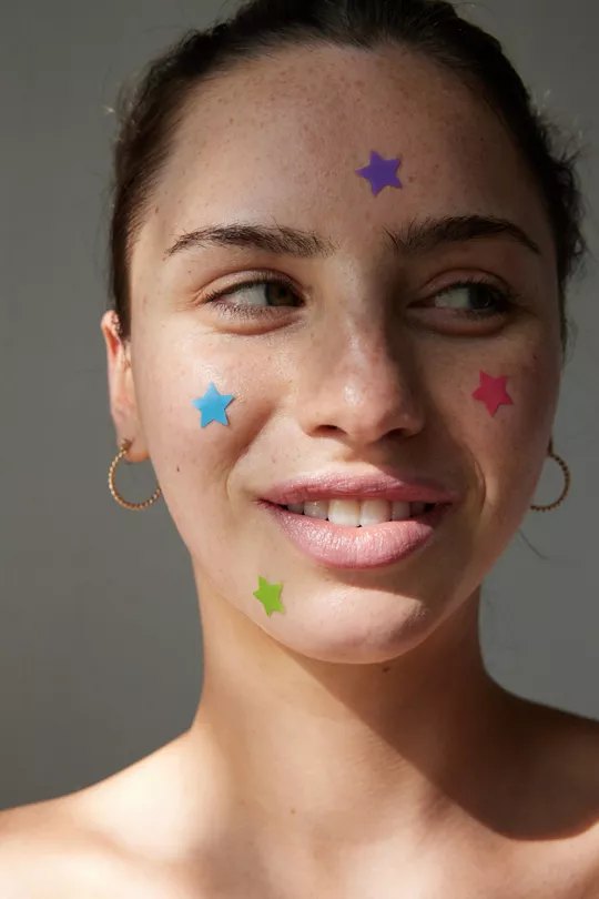 Starface star-shaped pimple patches worn on a face, from the class case study.